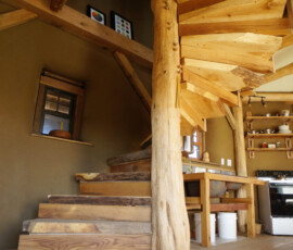 Custom wooden spiral staircase with round center post and "live edge" stair treads