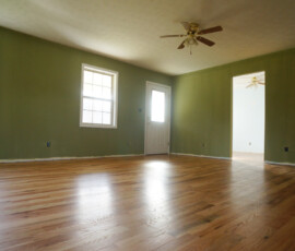 Remodeled living room with oak floors and milk painted walls