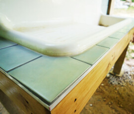 Tile counter around antique sink in outdoor kitchen