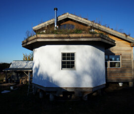 Lime plaster on straw bale home exterior